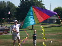 La Grande back pain free grandpa and grandson playing with a kite